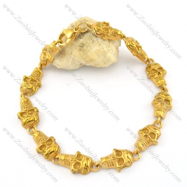 11 small skull heads bracelet in gold tone b002342